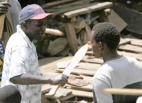 [20080111 (LA/A9) -- IN NAIROBI: A suspected member of a Kikuyu criminal gang threatens a man at a food aid center in the Kibera slum. The failure of envoys to broker a peace raised fears of renewed rioting. -- PHOTOGRAPHER: Karel Prinsloo  Associated Press] *** [A member of a feared Kikuyu criminal gang, the Mungiki , threaten a man with a machete as they arrive at a Red Cross food distribution point to protect people receiving food aid, in the Kibera slum in Nairobi, Thursday Jan. 10, 2008. Police fired tear gas to scatter women opposition supporters marching through Kenya's capital on Thursday calling for peace and justice, and civil rights groups demanded officials be prosecuted for allegedly falsifying election results.(AP Photo/Karel Prinsloo)] ** Usable by LA and DC Only **