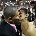 A couple kisses during a mass wedding ceremony during the fifth edition of "The Greater Saint John of the Cerrado" festival in Brasilia