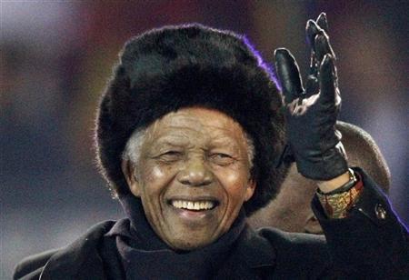 Former South African President Mandela waves to crowd at Soccer City stadium during the closing ceremony for the 2010 World Cup in Johannesburg