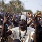 Anti-government demonstrators take to the streets during a protest against Senegal President Abdoulaye Wade"s decision to seek a third term in the capital Dakar, January 31, 2012.