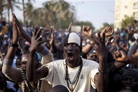 Anti-government demonstrators take to the streets during a protest against Senegal President Abdoulaye Wade"s decision to seek a third term in the capital Dakar, January 31, 2012.
