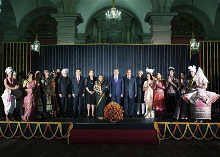 (From 9th L) India's Prime Minister Manmohan Singh, Chinese President Hu Jintao, Brazil's President Dilma Rousseff, India's President Pratibha Patil, Russian President Dmitry Medvedev, South Africa's President Jacob Zuma and India's Vice President Mohammad Hamid Ansari pose with artists during a cultural programme and banquet hosted by Patil at the presidential palace in New Delhi March 28, 2012. Hu, Medvedev, Rousseff and Zuma are scheduled to attend the BRICS (Brazil, Russia, India, China and South Africa) Summit in India on March 29. REUTERS/Presidential Palace/Handout