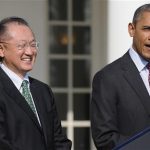 Dartmouth College president Jim Yong Kim (L) smiles as U.S. President Barack Obama