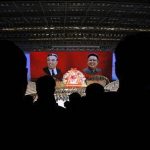 Portrait of North Korea founder Kim Il-sung (L) and late leader Kim Jong-il are shown during a concert in Pyongyang April 16, 2012. REUTERS/Bobby Yip