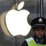 A security guard stands in front of an Apple store in downtown Shanghai in this February 18, 2012 file photo. REUTERS/Aly Song/Files