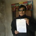 Blind legal activist Chen Guangcheng holds a petition in his village home in Linyi in eastern Shandong province, in this still image taken from file video. REUTERS/Chinaaid via Reuters TV/Handout