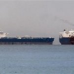 Vessels sail past Malta-flagged Iranian crude oil supertanker "Delvar" (L) anchoring off Singapore March 1, 2012. REUTERS/Tim Chong