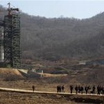 Journalists leave in front of the Unha-3 (Milky Way 3) rocket is pictured sitting on a launch pad at the West Sea Satellite Launch Site, during a guided media tour by North Korean authorities in the northwest of Pyongyang April 8, 2012. REUTERS/Bobby Yip