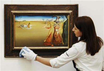 A Sotheby's employee poses with Salvador Dali's 

"Oasis" at Sotheby's auction house in London February 1, 2012. REUTERS/Luke MacGregor