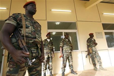 Soldiers stand
guard during the funeral of armed forces chief of staff General Batista Tagme Na Wai at the military headquarters in Bissau Soldiers stand guard during the funeral of armed
forces chief of staff General Batista Tagme Na Wai at the military headquarters in Bissau, March 8, 2009. REUTERS/Luc Gnago
