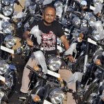 Chief Executive Officer of Royal Enfield Motors, Venki Padmanabhan, poses with newly manufactured motorcycles at its factory in the southern Indian city of Chennai April 16, 2012. REUTERS/Babu