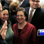 The U.S. Supreme Court's newest member, Associate Justice Elena Kagan (C) poses for a picture with other guests at a Hanukkah reception in the East Room of the White House in Washington, in this December 2, 2010, file photo. During three days of arguments over the Obama healthcare plan, Supreme Court Justice Kagan put on a display of rhetorical firepower, reinforcing predictions that the newest liberal justice is best equipped to take on the conservative, five-man majority controlling the bench. REUTERS/Jason Reed/Files