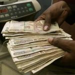 A currency dealer counts Kenya shillings at a money exchange counter in Nairob, Kenya, October 23, 2008. REUTERS/Antony Njuguna