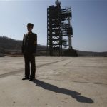 A soldier stands guard in front of the Unha-3 (Milky Way 3) rocket sitting on a launch pad at the West Sea Satellite Launch Site, during a guided media tour by North Korean authorities in the northwest of Pyongyang April 8, 2012. REUTERS/Bobby Yip
