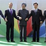 (From L-R) Brazil's President Dilma Rousseff, Russian President Dmitry Medvedev, Indian Prime Minister Manmohan Singh, Chinese President Hu Jintao and South African President Jacob Zuma join their hands together during a group photo for the BRICS Summit in New Delhi March 29, 2012. REUTERS/B Mathur