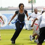 First lady Michelle Obama plays flag football with children and former NFL players and coaches during her "Let's Move" campaign to fight childhood obesity in New Orleans in this file photo taken September 8, 2010. REUTERS/Cheryl Gerber/Files