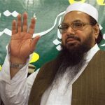 Hafiz Mohammad Saeed, head of Jamaat-ud-Dawa and founder of Lashkar-e-Taiba, waves to the media after a news conference in Rawalpindi near Islamabad April 4, 2012. The U.S. has posted a $10 million reward for help in the arrest of Pakistani Islamist leader Saeed, suspected of masterminding attacks on India's financial capital and its parliament. REUTERS/Faisal Mahmood