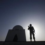 A paramilitary personnel is silhouetted against the sun as he stands guard during a ceremony to mark the country's Pakistan Day (Resolution Day) celebrations at the mausoleum of Mohammad Ali Jinnah in Karachi March 23, 2012. REUTERS/Athar Hussain