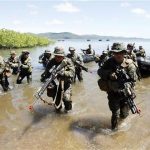 Philippine and U.S. marine soldiers wade in shallow water in a bay during a amphibious raid as part of a Philippine-U.S. joint military exercise in Ulugan bay, western coast of Philippines April 25, 2012. REUTERS/Romeo Ranoco