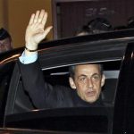 France's President and UMP party candidate for the 2012 French presidential elections Nicolas Sarkozy waves from his car as he rides on the way to addresses supporters at La Mutualite meeting hall in Paris after early results in the first round vote of the 2012 French presidential election April 22, 2012. REUTERS/Jean-Paul Pelissier