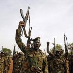 South Sudan's SPLA soldiers hold up their weapons as they shout at a military base in Bentiu April 22, 2012. REUTERS/Goran Tomasevic