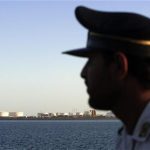 A security personnel looks on at oil docks at the port of Kalantari in the city of Chabahar, 300km (186 miles) east of the Strait of Hormuz January 17, 2012. REUTERS/Raheb Homavandi