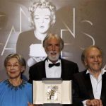 Director Michael Haneke poses with actors Emmanuelle Riva (L) and Jean-Louis Trintignant (R) during a photocall after receiving the Palme d'Or award for the film "Amour" (Love) at the 65th Cannes Film Festival, May 27, 2012. REUTERS/Jean-Paul Pelissier