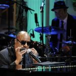 Stevie Wonder plays the harmonica as he performs the song Alfie during a concert in the East Room of the White House, May 9, 2012. REUTERS/Jonathan Ernst