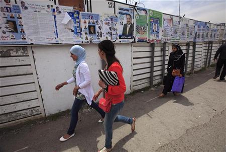 Women walk past electoral posters in Algiers Women walk past electoral posters in Algiers May 9,
2012. REUTERS/Zohra Bensemra