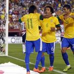 Brazil's Marcelo (C) celebrates scoring a goal with teammates Neymar (11) and Hulk, as goalkeeper Tim Howard of the U.S. (far L) reacts during an international friendly soccer match in Landover, Maryland, May 30, 2012. REUTERS/Jason Reed