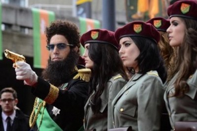 Actor Sacha Baron Cohen, playing
Admiral General Aladeen, points a gun as he poses with models at the world premiere of the Dictator at
the Royal Festival Hall in London May 10, 2012. REUTERS/Dylan Martinez (BRITAIN - Tags:
ENTERTAINMENT SOCIETY)