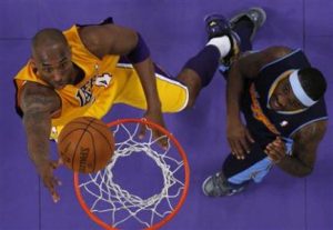 Los Angeles Lakers' Kobe 

Bryant (L) puts up a shot past Denver Nuggets' Ty Lawson during Game 7 of their NBA Western Conference 

basketball playoff series in Los Angeles, California May 12, 2012. REUTERS/Lucy Nicholson