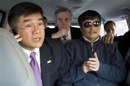 A handout photo from the U.S. Embassy Beijing Press office shows U.S. Ambassador to China Gary Locke (L) talking on a mobile phone as he accompanies blind activist Chen Guangcheng (R) in a car, in Beijing, May 2, 2012. Picture taken May 2, 2012. REUTERS/US Embassy Beijing Press Office/Handout