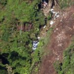The logo of Sukhoi Co. is clearly visible, center, among the wreckage of a Sukhoi Superjet-100 scattered on the mountainside in Bogor, West Java, Indonesia, Friday, May 11, 2012. The crash of the new, Russian-made jetliner into a jagged Indonesian volcano during a flight to impress potential buyers has thrown doubt on dozens of plane sales just as Moscow seeks a comeback in foreign markets. All 45 people aboard were feared dead. (AP Photo)