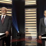 Egyptian presidential hopefuls Amr Moussa (R) and Abdel Moneim Abol Fotouh smile during a televised debate in Cairo May 10, 2012. REUTERS/Almasry Alyoum Newspaper /Mahmoud Khaled /Handout