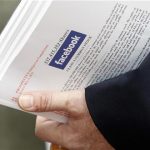 An investor holds prospectus explaining the Facebook stock after attending a show for Facebook Inc's initial public offering at the Four Season's Hotel in Boston, Massachusetts May 8, 2012. REUTERS/Jessica Rinaldi