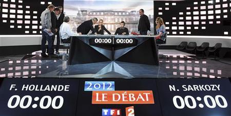 People work at the television studio in La Plaine Saint-Denis, near Paris, on the eve of the televised debate for the 2012 French presidential election campaign between Nicolas Sarkozy, France's President and UMP party candidate for his re-election, and Francois Hollande, Socialist party candidate, May 1, 2012. REUTERS/Franck Fife/Pool