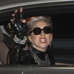 U.S. singer Lady Gaga waves upon her arrival for her concert tour, at Don Muang Airport in Bangkok May 23, 2012. REUTERS/Sukree Sukplang