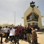 Workers from the Arabian Gulf Oil Co gather at the locked main entrance to the company during a protest against embezzlement, in Benghazi April 23, 2012. REUTERS/Esam Al-Fetori