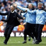 Manchester City's manager Roberto Mancini (L) celebrates with backroom staff after Sergio Aguero scored the winning goal during their English Premier League match against Queens Park Rangers at the Etihad Stadium, May 13, 2012. REUTERS/Phil Noble