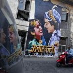 A man rides a motorbike past a mural of the classic Bollywood movie "Anarkali" on the wall of a building in Mumbai May 13, 2012. The mural is the brainchild of a pair of movie buffs, Ranjit Dahiya and Tony Peter, who hope to give Mumbai a distinct Bollywood identity through a series of murals, aiming for the iconic appeal of the "Hollywood" sign in California. The mural from Anarkali, a 1953 film about a doomed love affair between the prince and a commoner, is just the first of many the pair, and their Bollywood Art Project, hope to create all over the city. Picture taken May 13, 2012. To match story INDIA-BOLLYWOOD/MURAL REUTERS/Vivek Prakash