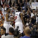 The 76ers' Evan Turner (left) and Andre Iguodala rejoice with fans after beating the Bulls to advance