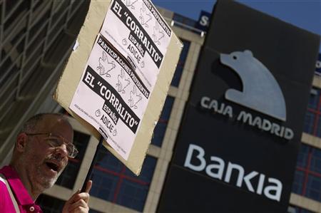 A man shouts slogans during a protest outside headquarters of Spain's fourth largest bank Bankia in Madrid A man shouts slogans during a protest outside headquarters of Spain's fourth largest bank Bankia in Madrid May 24, 2012. REUTERS/Sergio Perez