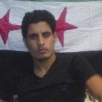 Abdelbasset Saroot, former Syria international goalkeeper, is seen in front of opposition flag in this undated photograph received on May 2, 2012. Syrian opposition has said on Wednesday that Abdelbassed was wounded by pro government sniper in Al Khalidieh in Homs on Wednesday but is in good health. 20-year-old Saroot said on Tuesday his country's athletes do not want to compete in this year's London Olympics because "they don't want to play for a flag that they have no pride or faith in" in an interview with ITV News. REUTERS/Handout