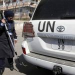 A security employee examines a vehicle carrying members from an international observers mission in Syria at the entrance of the U.N. headquarters in Damascus May 13, 2012. REUTERS/Khaled al-Hariri