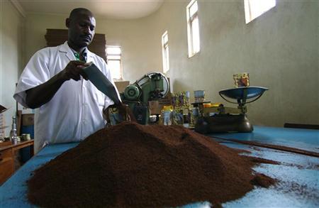 To match interview: TANZANIA-COFFEE/ A worker prepares tins of ground coffee for local consumption in Tanzania, December 10, 2009. REUTERS/Katrina Manson