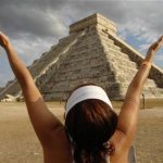 A woman raises her arms to receive energy from the sun at the Mayan pyramid El Castillo (The Castle), in Chichen Itza, in the southern state of Yucatan, Mexico March 21, 2009. REUTERS/Argely Salazar