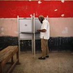 A voter prepares to cast his vote at a polling station in Cairo June 17, 2012. A second day of voting on Sunday will deliver Egypt's first freely elected president, though the country faces renewed tension whether he is a former general from the old guard or an Islamist from the long-suppressed Muslim Brotherhood. REUTERS/Ahmed Jadallah
