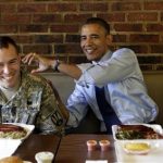 U.S. President Barack Obama jests with U.S. Army 1st Lt. Bill Edwards as they eat at Kenny's BBQ in honor of the upcoming Father's Day weekend in Washington June 13, 2012. REUTERS/Kevin Lamarque