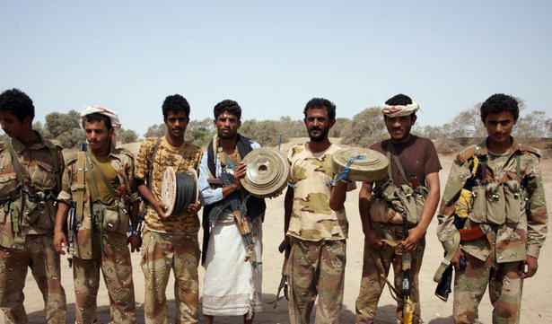 Yemeni soldiers pose with munition they found on June 13, after the army seized the Al Qaeda strongholds of Jaar and Zinjibar on June 12. Yemen government poised to seize third town from Al Qaeda